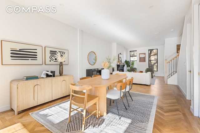 dining space featuring stairway and baseboards