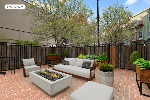 view of patio / terrace with an outdoor living space with a fire pit