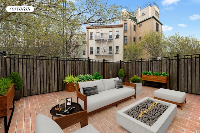 view of patio featuring an outdoor living space with a fire pit