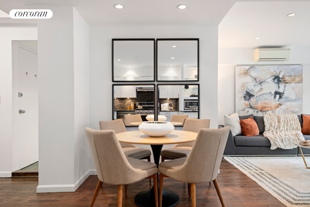 dining room with an AC wall unit and dark hardwood / wood-style floors