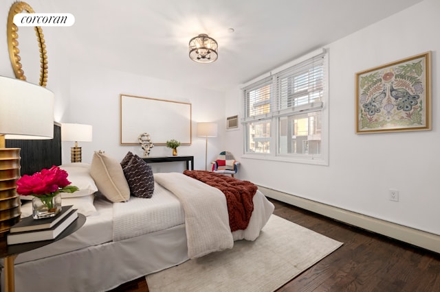 bedroom featuring dark wood-type flooring and a baseboard radiator