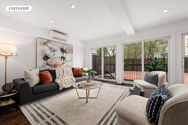 living area featuring visible vents, beamed ceiling, a wall mounted air conditioner, recessed lighting, and wood finished floors