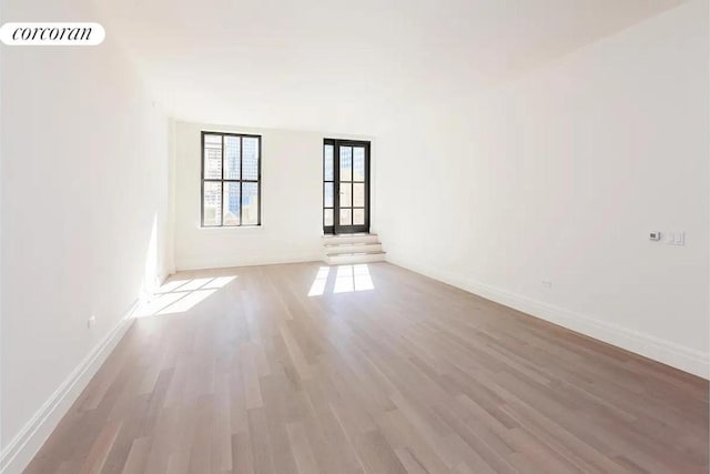 spare room featuring light hardwood / wood-style flooring