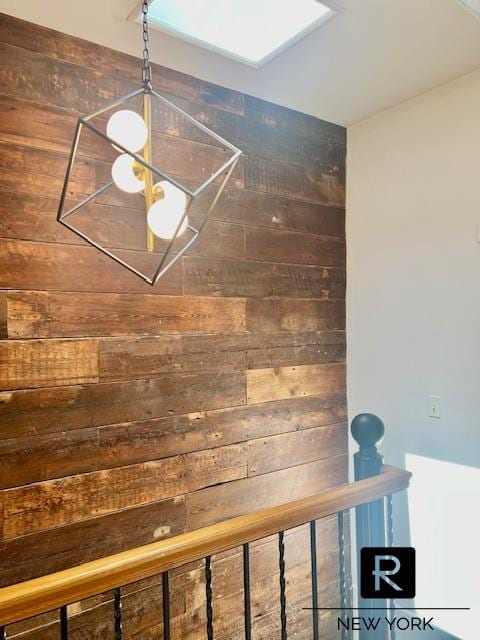 room details featuring wood walls and a skylight