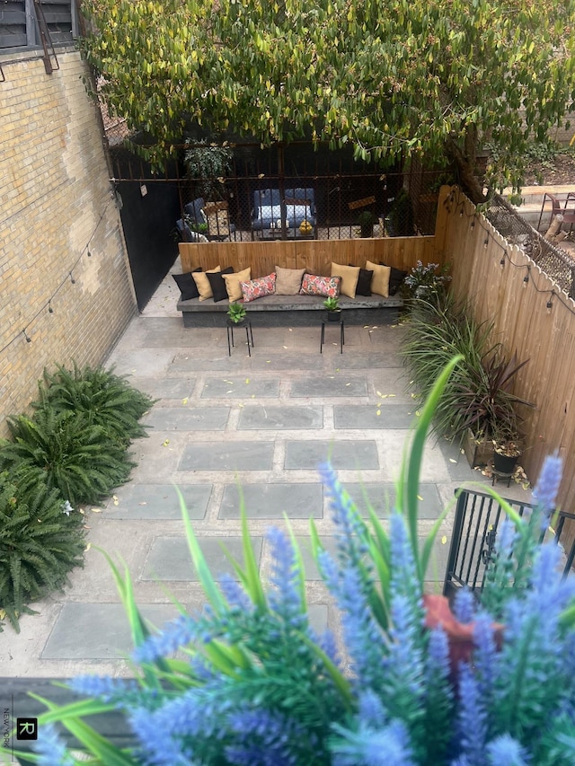 view of patio featuring fence and an outdoor living space