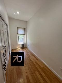 hallway with wood-type flooring