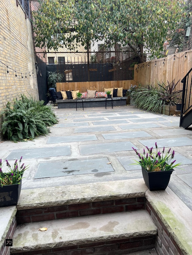 view of patio / terrace featuring fence and an outdoor hangout area