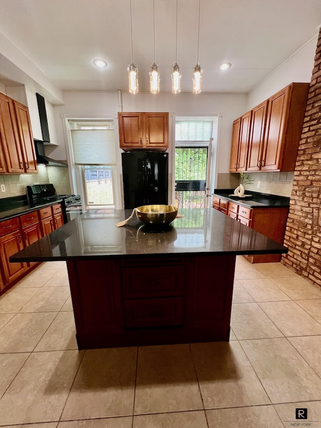 kitchen featuring black appliances, dark countertops, backsplash, and a kitchen island