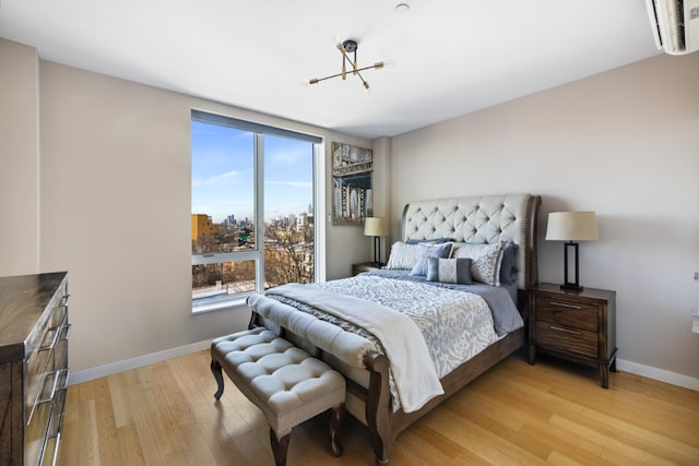 bedroom with light wood-style flooring and baseboards