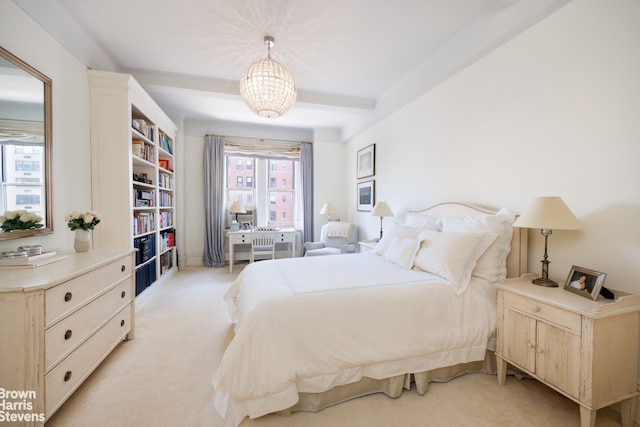 carpeted bedroom with a notable chandelier and beam ceiling