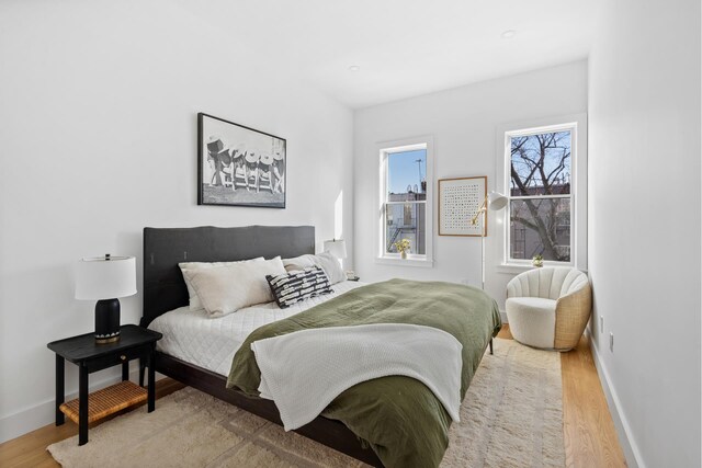 bedroom with wood finished floors and baseboards