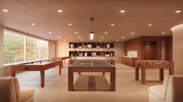 game room with light wood-style flooring and recessed lighting