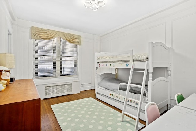 bedroom featuring dark wood-type flooring and radiator heating unit