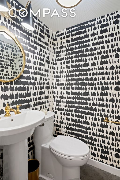 bathroom featuring sink, tile patterned floors, and toilet