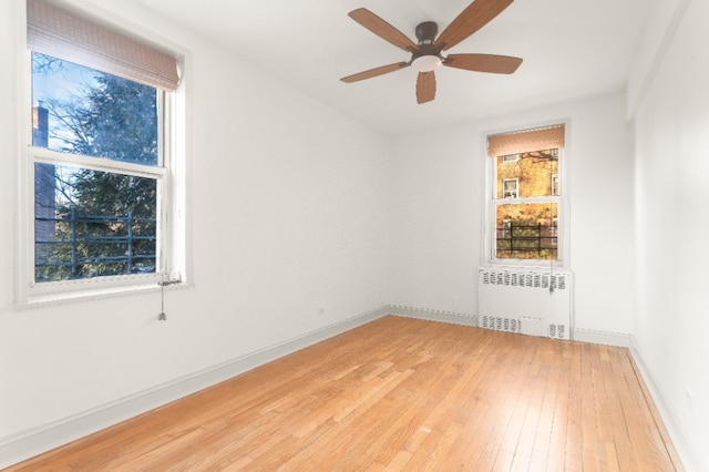 5610 Netherland Ave Unit 2A, New York City, NY 10471 - spare room featuring radiator heating unit, light wood finished floors, ceiling fan, and baseboards