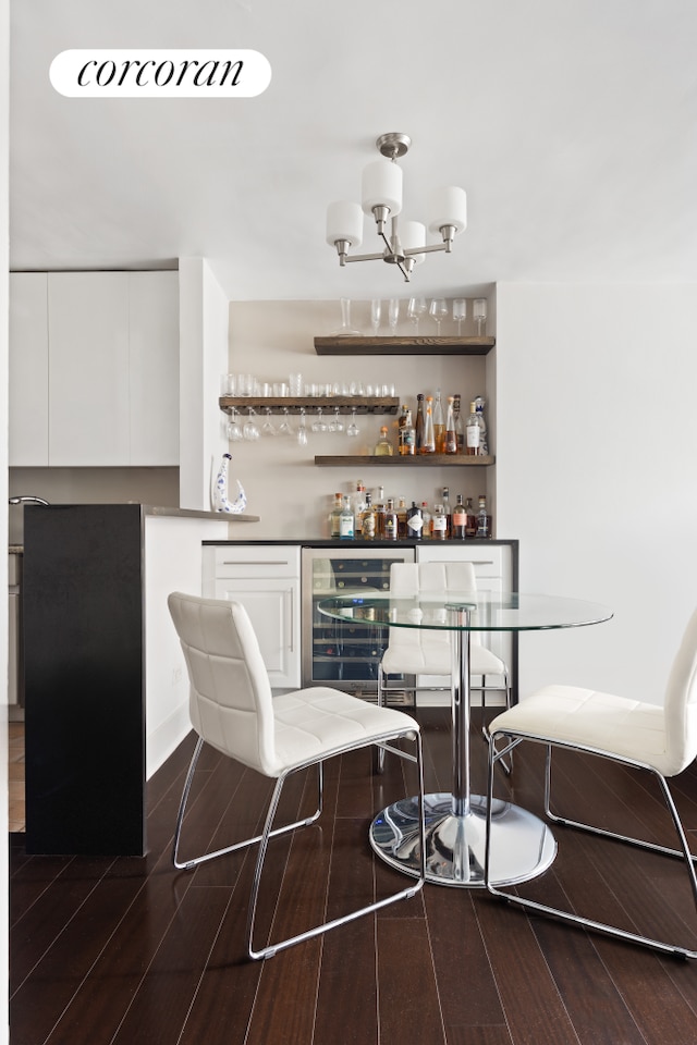 32 Gramercy Park S Unit 7F, New York City, NY 10003 - indoor dry bar featuring beverage cooler, dark wood-style floors, and a chandelier