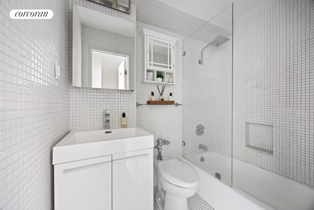 32 Gramercy Park S Unit 7F, New York City, NY 10003 - full bathroom with tile walls, toilet, washtub / shower combination, and vanity
