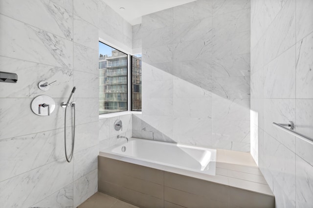 full bathroom featuring a garden tub, tile walls, and tiled shower