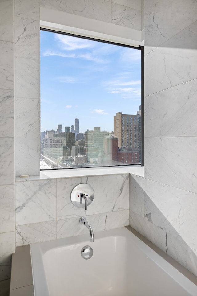 full bath with a tub to relax in and a city view