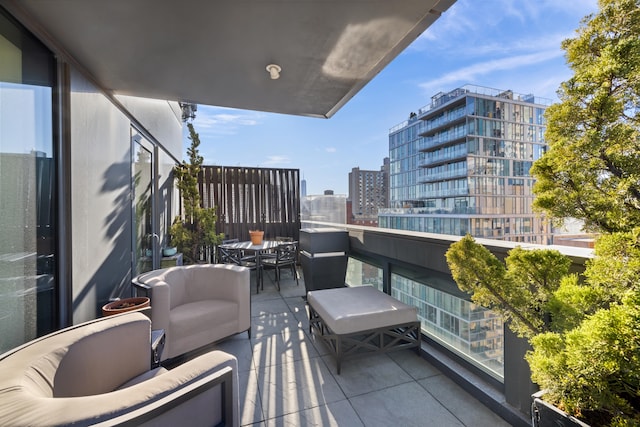 balcony featuring a view of city and outdoor lounge area