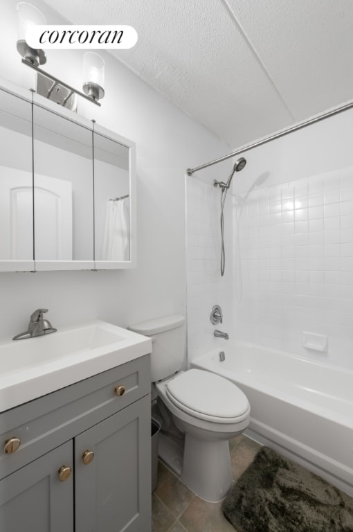 full bathroom featuring shower / bath combination, vanity, a textured ceiling, and toilet