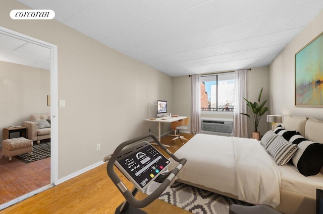 bedroom with hardwood / wood-style flooring and cooling unit