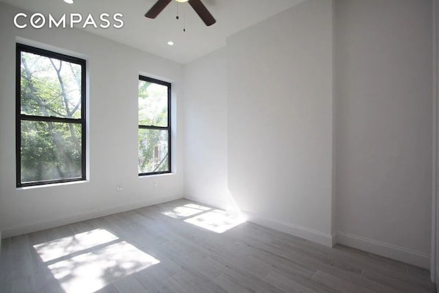 unfurnished room featuring ceiling fan, wood-type flooring, and vaulted ceiling