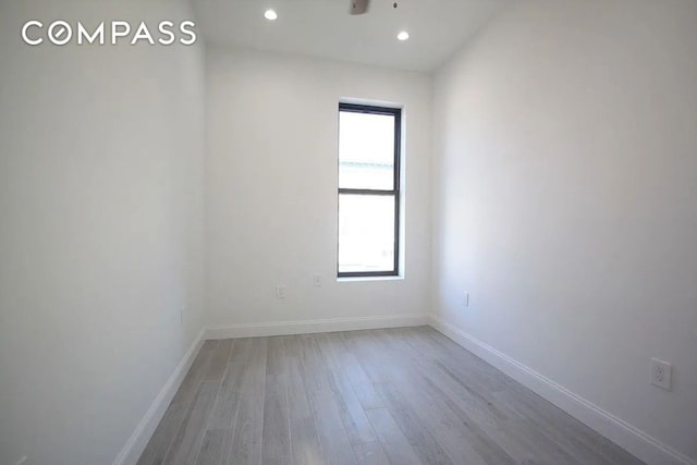 empty room with light hardwood / wood-style flooring