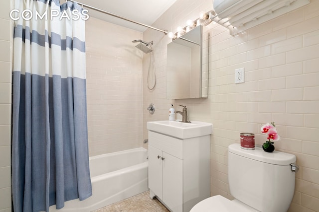 bathroom with shower / bathtub combination with curtain, toilet, tile walls, and vanity