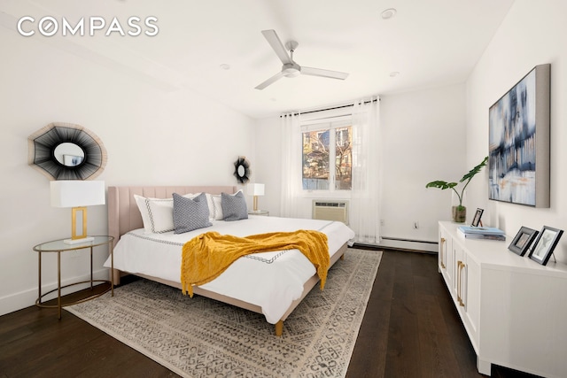 bedroom with dark wood-style floors, baseboard heating, a wall mounted air conditioner, and ceiling fan