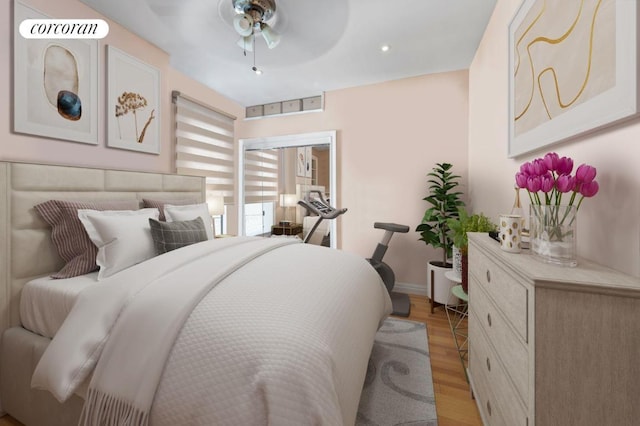 bedroom with ceiling fan and light hardwood / wood-style floors