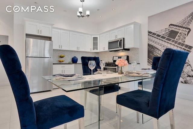 kitchen featuring stainless steel appliances, white cabinets, and decorative backsplash