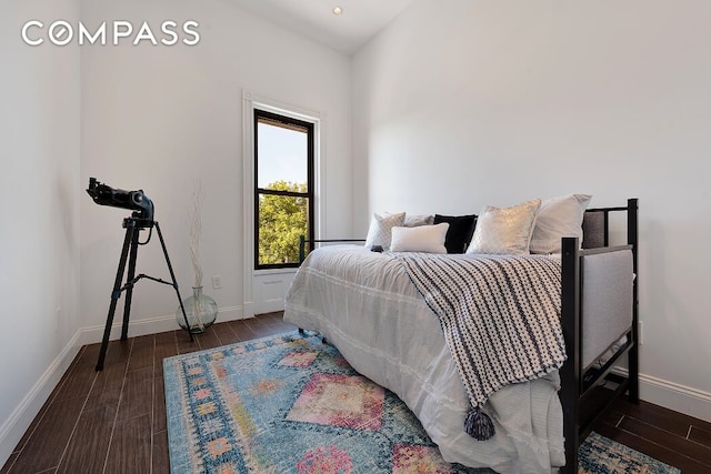 bedroom with dark hardwood / wood-style flooring