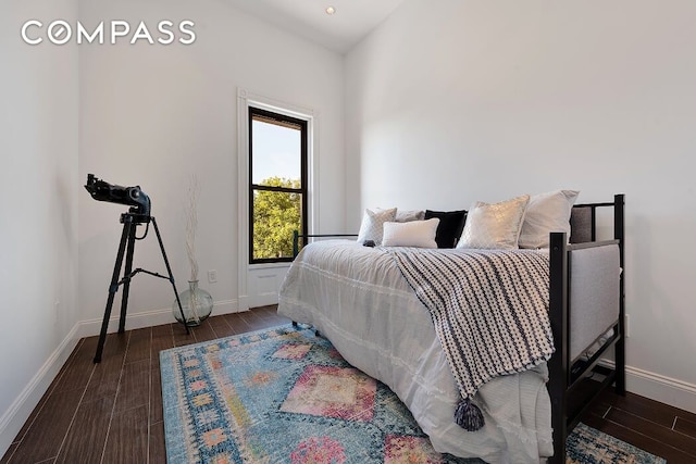 bedroom with baseboards and wood finished floors