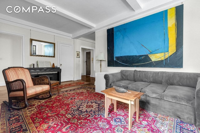 living room featuring beamed ceiling and wood-type flooring