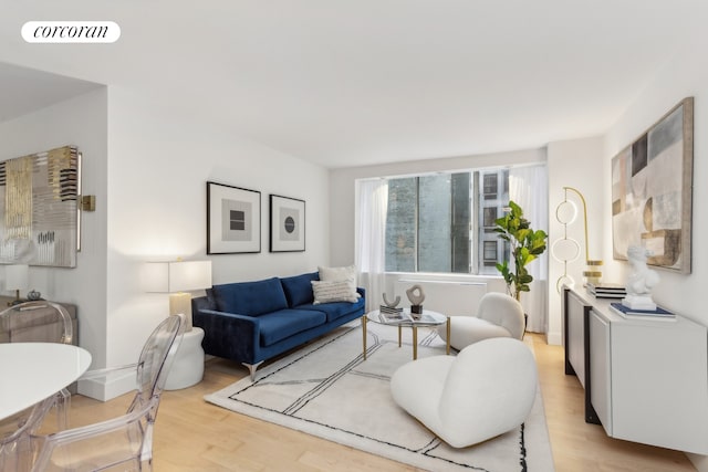 living room with visible vents, baseboards, and light wood-style floors