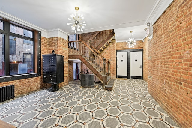 unfurnished living room with a chandelier, ornamental molding, stairway, and brick wall