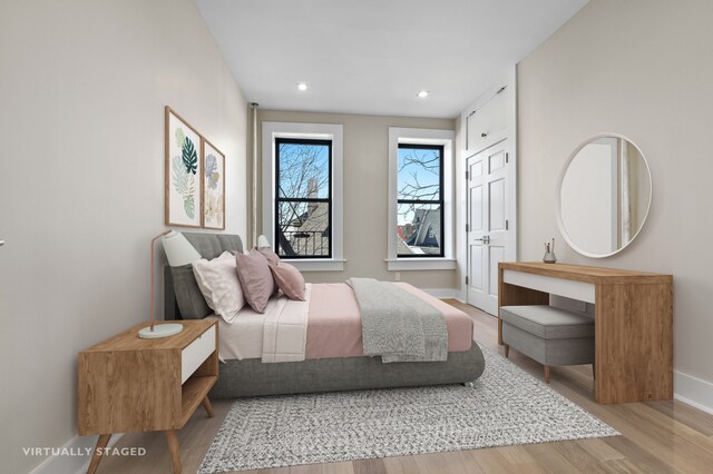 bedroom with recessed lighting, baseboards, and wood finished floors