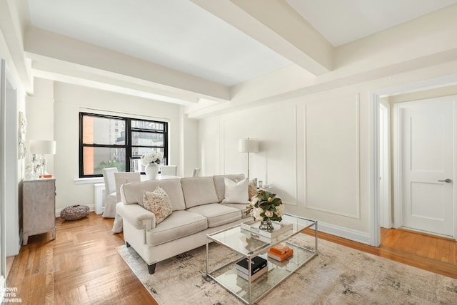 living room featuring beamed ceiling and light parquet flooring