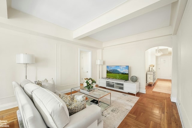 living room with beam ceiling and parquet flooring