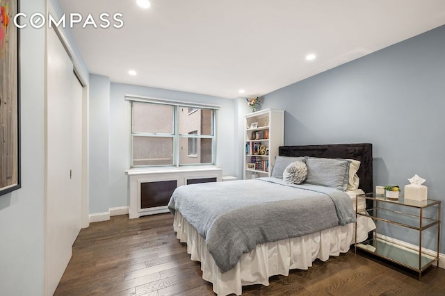 bedroom featuring dark hardwood / wood-style flooring and a closet