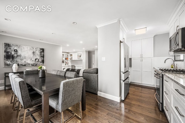 dining area featuring crown molding and dark hardwood / wood-style flooring