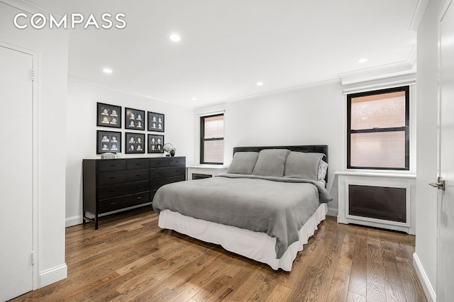 bedroom featuring wood-type flooring, baseboards, crown molding, and recessed lighting