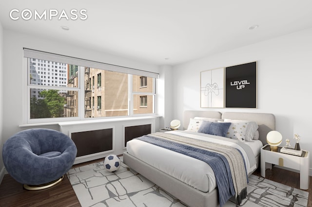 bedroom with wood finished floors and recessed lighting