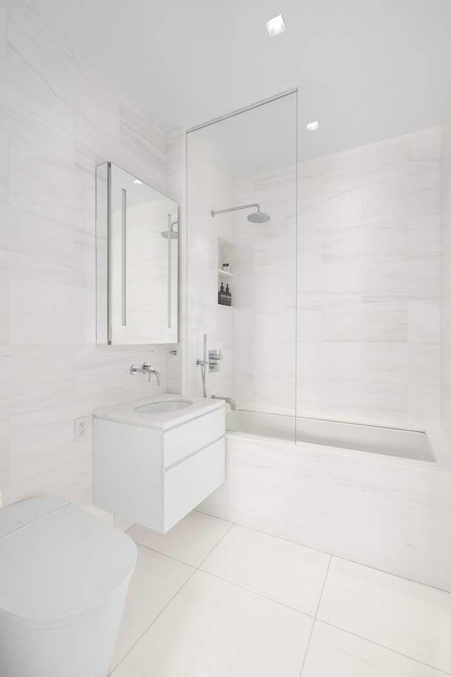 full bathroom with tile patterned flooring, toilet, tile walls, and bathing tub / shower combination