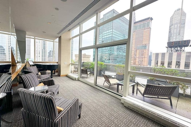 sunroom featuring a city view