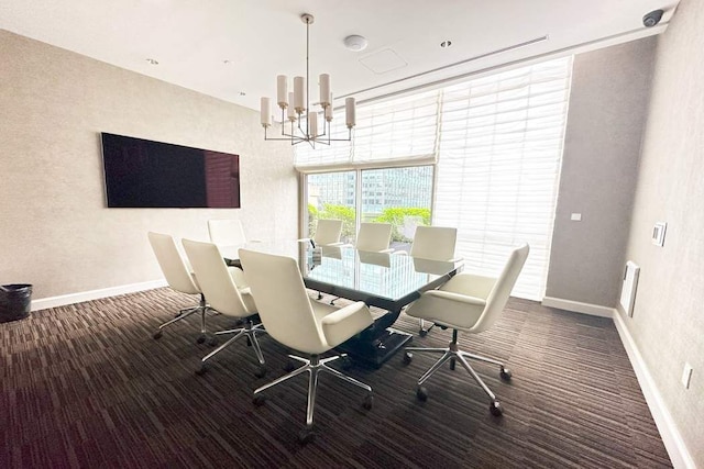 dining space featuring carpet flooring, baseboards, and a chandelier