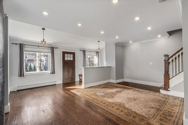 unfurnished living room with a baseboard heating unit, crown molding, and dark hardwood / wood-style floors