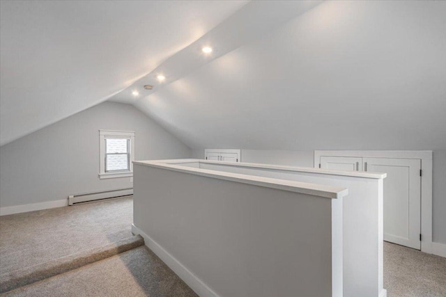 bonus room with lofted ceiling, light colored carpet, and baseboard heating