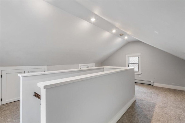 bonus room with a baseboard radiator, vaulted ceiling, and light carpet